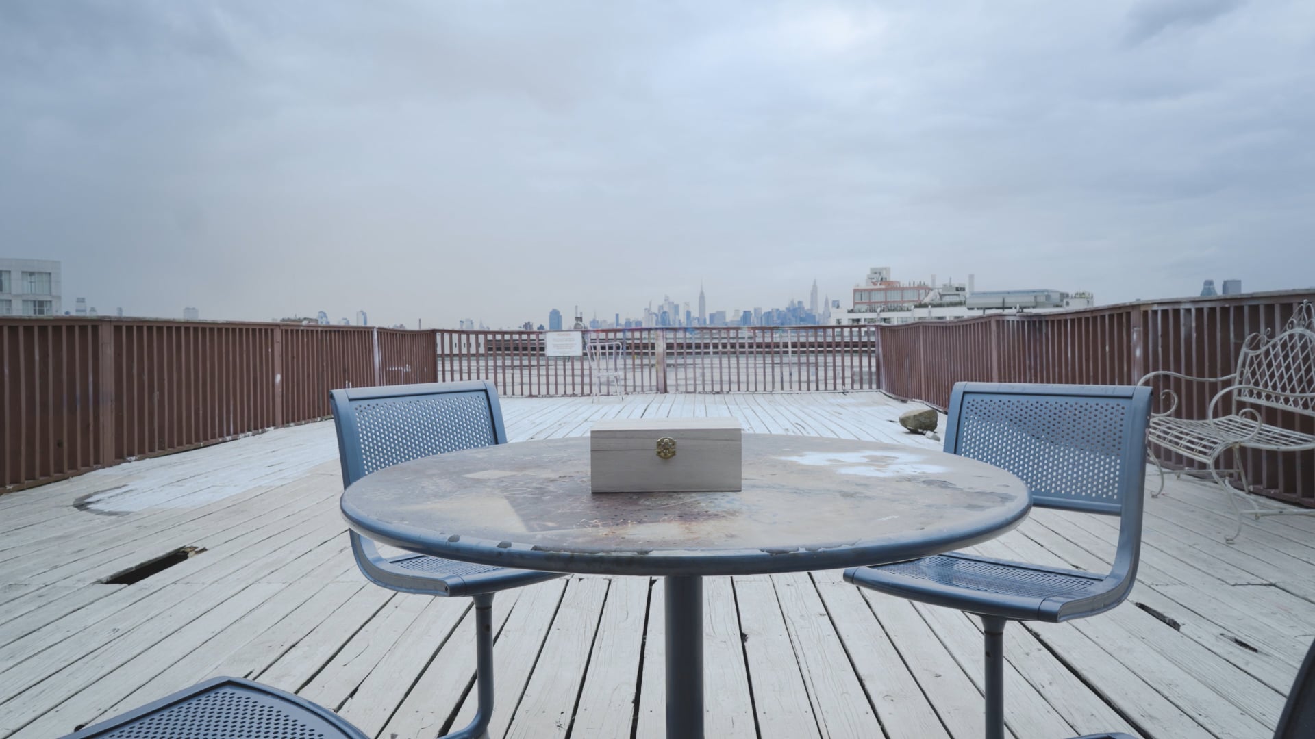 A Letter film still — rooftop table with a wooden box