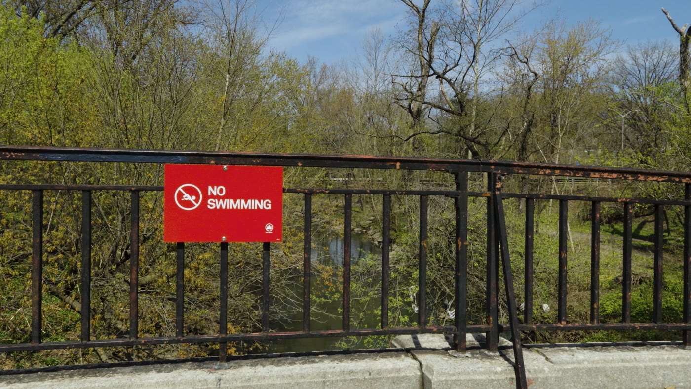No Swimming sign on a bridge over the Bronx River